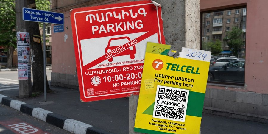 Strisce rosse di parcheggio a pagamento e adesivo Telcell nel centro di Yerevan