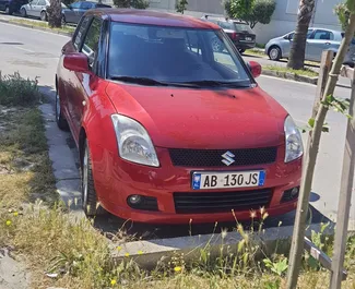 Vista frontale di un noleggio Suzuki Swift a Durazzo, Albania ✓ Auto #8608. ✓ Cambio Manuale TM ✓ 0 recensioni.