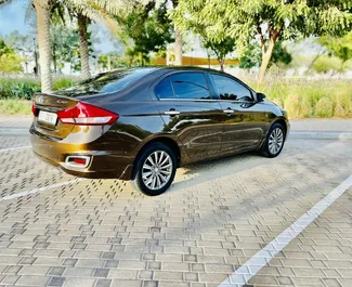 Noleggio auto Suzuki Ciaz #9130 Automatico all'aeroporto di Dubai Al Maktoum, dotata di motore 1,5L ➤ Da Mikael negli Emirati Arabi Uniti.