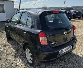 Vista frontale di un noleggio Nissan Micra all'aeroporto di Tirana, Albania ✓ Auto #9370. ✓ Cambio Manuale TM ✓ 0 recensioni.