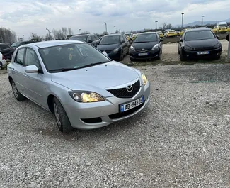 Vista frontale di un noleggio Mazda 3 all'aeroporto di Tirana, Albania ✓ Auto #11900. ✓ Cambio Manuale TM ✓ 0 recensioni.