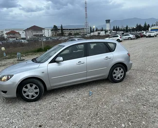 Noleggio Mazda 3. Auto Economica, Comfort per il noleggio in Albania ✓ Cauzione di Deposito di 100 EUR ✓ Opzioni assicurative RCT, CDW, SCDW, FDW, Furto, All'estero, Giovane, Senza deposito.