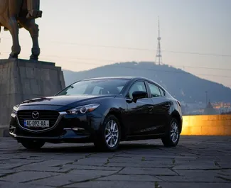 Vista frontale di un noleggio Mazda 3 a Tbilisi, Georgia ✓ Auto #10158. ✓ Cambio Automatico TM ✓ 0 recensioni.