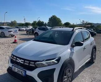 Vista frontale di un noleggio Dacia Sandero Stepway all'aeroporto di Tirana, Albania ✓ Auto #10103. ✓ Cambio Manuale TM ✓ 1 recensioni.