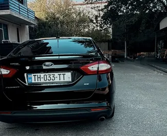 Noleggio Ford Fusion Sedan. Auto Comfort, Premium per il noleggio in Georgia ✓ Cauzione di Deposito di 200 GEL ✓ Opzioni assicurative RCT, CDW, SCDW, Passeggeri, Furto, Senza deposito.