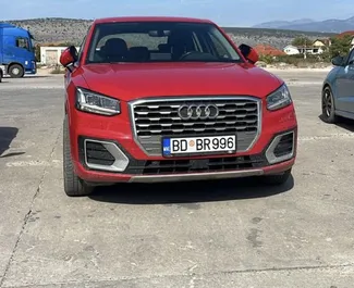 Vista frontale di un noleggio Audi Q2 all'aeroporto di Podgorica, Montenegro ✓ Auto #15662. ✓ Cambio Automatico TM ✓ 0 recensioni.