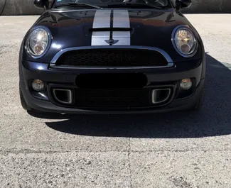 Vista frontale di un noleggio Mini Cooper S Cabrio a Budva, Montenegro ✓ Auto #16573. ✓ Cambio Manuale TM ✓ 0 recensioni.